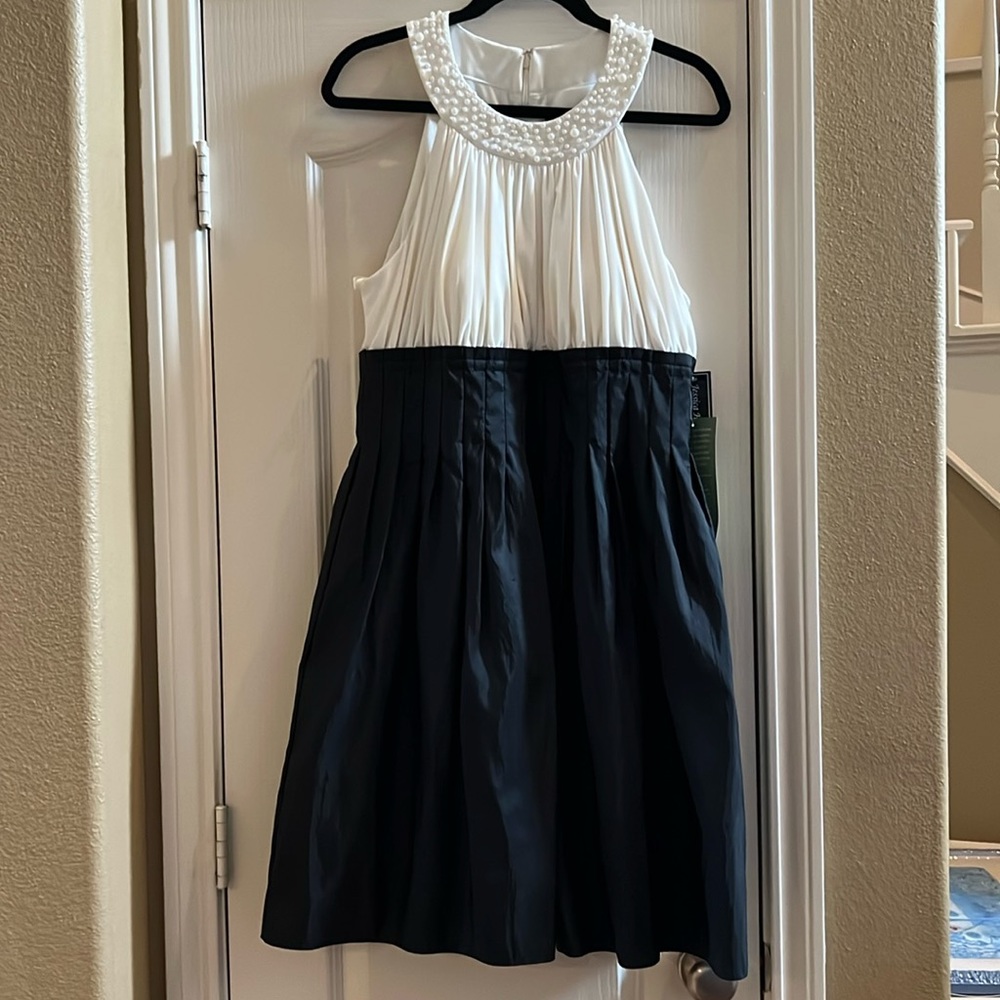 Sleeveless ivory & black cocktail length dress with taffeta skirt & ruched top
